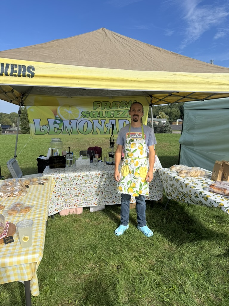 Our outdoor lemonade and baked-goods stand beneath a yellow canopy